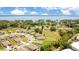 An aerial view showcasing a neighborhood near a lake, highlighting the home's location and surroundings at 2668 Grand Central Ave, Tavares, FL 32778