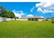 Large backyard with a privacy fence, offering plenty of space for outdoor activities and relaxation at 2668 Grand Central Ave, Tavares, FL 32778