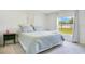 Bright bedroom with a window overlooking the backyard and plush carpet at 2668 Grand Central Ave, Tavares, FL 32778