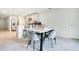 Elegant dining area with a marble-top table and stylish chairs, adjacent to an open kitchen at 2668 Grand Central Ave, Tavares, FL 32778