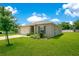 Beautiful single-story home with a lush green lawn, showcasing its well-maintained landscaping at 2668 Grand Central Ave, Tavares, FL 32778
