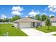 Inviting single-story home with a manicured lawn, features an attached garage and clean design at 2668 Grand Central Ave, Tavares, FL 32778