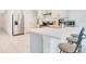 Well-lit kitchen featuring stainless steel appliances, sleek countertops, and breakfast bar seating at 2668 Grand Central Ave, Tavares, FL 32778