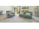 Bright living room with plush carpeting, large windows, and comfortable seating area at 2668 Grand Central Ave, Tavares, FL 32778