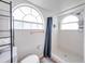 Bright bathroom featuring two arched windows with lots of shelf space at 2729 N Poinciana Blvd # 125, Kissimmee, FL 34746