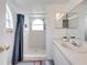 Bright bathroom featuring shower, arched window, vanity, and blue accents at 2729 N Poinciana Blvd # 125, Kissimmee, FL 34746