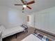 Comfortable bedroom featuring two twin beds, a ceiling fan, and ample closet space at 2729 N Poinciana Blvd # 125, Kissimmee, FL 34746