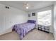 Bedroom with door and window, featuring a ceiling fan and patterned bed spread at 2729 N Poinciana Blvd # 125, Kissimmee, FL 34746