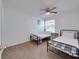 Bright bedroom with two twin beds, ceiling fan, and natural light creating a cozy and inviting atmosphere at 2729 N Poinciana Blvd # 125, Kissimmee, FL 34746