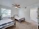 Inviting bedroom with two twin beds, a fan, and natural light for a comfortable and airy space at 2729 N Poinciana Blvd # 125, Kissimmee, FL 34746