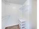 Walk in closet with shelving and container unit on a carpeted floor at 2729 N Poinciana Blvd # 125, Kissimmee, FL 34746