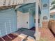 Blue condo entryway with a decorative welcome mat and red rock landscaping at 2729 N Poinciana Blvd # 125, Kissimmee, FL 34746