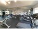 Spacious fitness center with various exercise machines, mirrored walls, and a television, for a complete workout at 2729 N Poinciana Blvd # 125, Kissimmee, FL 34746