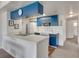 Compact kitchen with blue cabinetry and white appliances is ready for home-cooked meals at 2729 N Poinciana Blvd # 125, Kissimmee, FL 34746