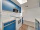 Well-lit kitchen with white appliances and blue cabinetry for a bright and inviting space at 2729 N Poinciana Blvd # 125, Kissimmee, FL 34746