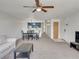 Open concept living and dining area with kitchen access, neutral carpet and bright light at 2729 N Poinciana Blvd # 125, Kissimmee, FL 34746