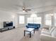Cozy living room with ceiling fan, large windows, neutral carpet, and comfortable seating at 2729 N Poinciana Blvd # 125, Kissimmee, FL 34746
