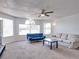 Bright living room with large windows, neutral carpet, ceiling fan, and comfortable seating at 2729 N Poinciana Blvd # 125, Kissimmee, FL 34746