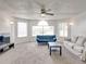 Comfortable living room featuring large windows, neutral carpet, ceiling fan, and sofas at 2729 N Poinciana Blvd # 125, Kissimmee, FL 34746