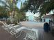 Relaxing pool deck with lounge chairs and lush trees, providing a tranquil space for residents at 2729 N Poinciana Blvd # 125, Kissimmee, FL 34746