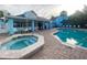 Inviting community pool area with a spa, lounge chairs, and a stylish clubhouse for resident enjoyment at 2729 N Poinciana Blvd # 125, Kissimmee, FL 34746