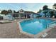 Community pool and hot tub, surrounded by lounge chairs and a clubhouse, perfect for relaxation at 2729 N Poinciana Blvd # 125, Kissimmee, FL 34746