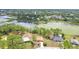 Aerial view of a home with a orange roof, adjacent to a lake at 2772 Pelham Cir, Deltona, FL 32738
