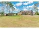 Expansive backyard featuring a screened-in pool area and lush green lawn at 2772 Pelham Cir, Deltona, FL 32738