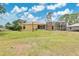 Large backyard with ample space, featuring a screened patio and a view of the house at 2772 Pelham Cir, Deltona, FL 32738