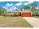Charming single-story home featuring a well-maintained lawn, bright exterior, and a two-car garage at 2772 Pelham Cir, Deltona, FL 32738