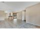 Open-concept living area with tile flooring connecting to kitchen and patio at 2772 Pelham Cir, Deltona, FL 32738