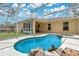 The screened-in pool area includes a built-in spa and rock waterfall feature at 2772 Pelham Cir, Deltona, FL 32738