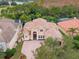 Gorgeous home with a tile roof surrounded by lush landscaping and a golf course at 2828 Northampton Ave, Orlando, FL 32828