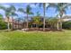Spacious backyard with lush green grass and a screened-in pool enclosure at 2828 Northampton Ave, Orlando, FL 32828