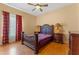 Bedroom with wood furniture, ceiling fan, and curtains at 2828 Northampton Ave, Orlando, FL 32828