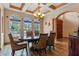 Formal dining room featuring a dark wood table, six chairs, and a chandelier, under a decorative ceiling at 2828 Northampton Ave, Orlando, FL 32828