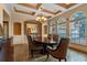 Formal dining room with a decorative tray ceiling, beautiful chandelier, and large windows offering plenty of natural light at 2828 Northampton Ave, Orlando, FL 32828