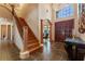 Spacious foyer boasts soaring ceilings, dark wood floors, a staircase, and a grand chandelier at 2828 Northampton Ave, Orlando, FL 32828