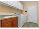 Laundry room with washer, dryer, sink and overhead cabinets at 2828 Northampton Ave, Orlando, FL 32828