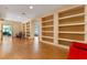 Open living room featuring custom built-in shelving, hardwood floors, and lots of natural light at 2828 Northampton Ave, Orlando, FL 32828