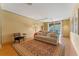 Relaxing living room with sofa, area rug, and natural light from sliding glass doors to a balcony at 2828 Northampton Ave, Orlando, FL 32828