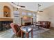 Spacious living room with a cozy fireplace, soaring ceilings, large windows, and comfortable seating at 2828 Northampton Ave, Orlando, FL 32828