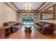 Bright living room with hardwood floors, leather furniture, and a sliding door view of the pool at 2828 Northampton Ave, Orlando, FL 32828