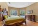 Serene main bedroom featuring hardwood floors, a large window and sliding door to the outside pool area at 2828 Northampton Ave, Orlando, FL 32828