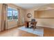 Bright home office with large window, wood floors, and cozy seating area at 2828 Northampton Ave, Orlando, FL 32828