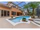 Enjoy the outdoors in a screened in patio area, featuring a pool, hot tub, and tropical plants at 2828 Northampton Ave, Orlando, FL 32828