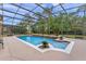 Screened in pool area with landscaping and clear water at 2828 Northampton Ave, Orlando, FL 32828