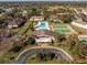 Aerial view of a clubhouse, swimming pool, and tennis courts in a neighborhood at 2930 S Semoran Blvd # 408, Orlando, FL 32822