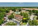 Aerial view of condo community with lush landscaping, pool, and ample parking at 2930 S Semoran Blvd # 408, Orlando, FL 32822