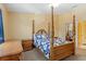 This charming bedroom features a decorative four-poster bed and matching wooden furniture at 2930 S Semoran Blvd # 408, Orlando, FL 32822